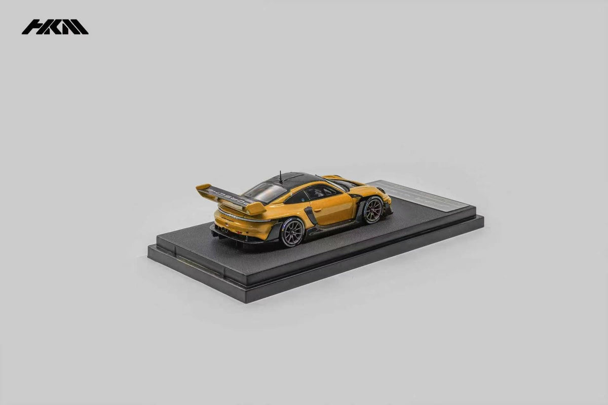 HKM Porsche 911 (992) GT3 R Rennsport in Signal Orange — rear view